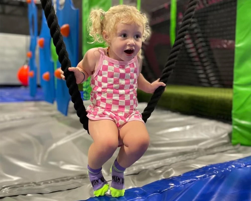 Kid Sitting on a Rope Swing